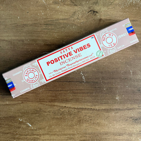 Box of Santa Positive Vibes Incense on a wooden surface