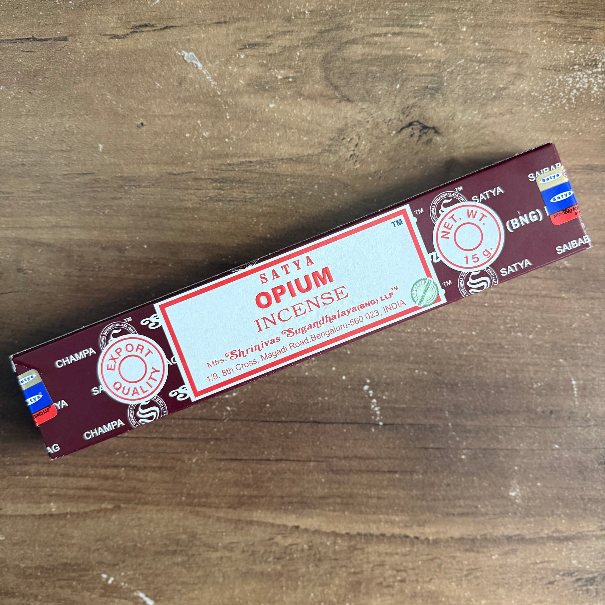 Satya Opium Incense packaging on a wooden surface